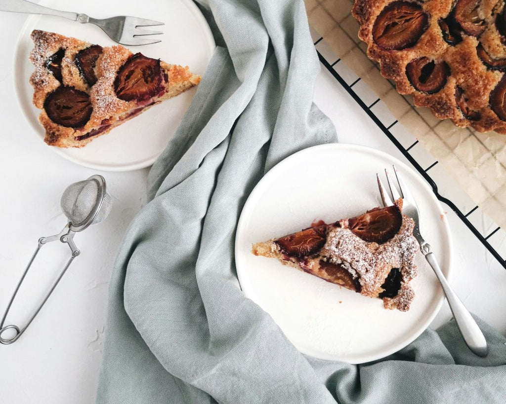 The Twig & Feather Sugar Plum Candle Collection - image showing sugared plum pie slices on grey tablecloth