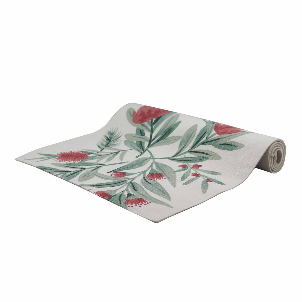 Rolled table runner with Australian native floral design on a white background
