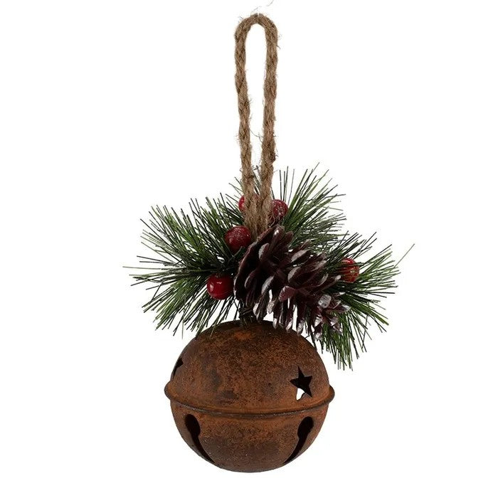 Decorative Christmas ornament with rusted bell, pine needles, and pine cones on a white background