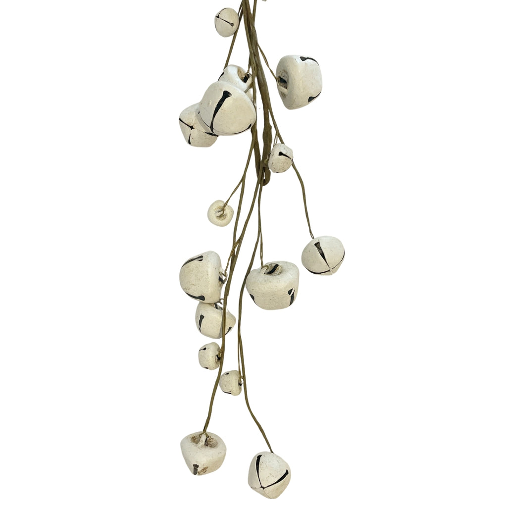 A garland of white metal bells with brown tape-covered wires  - closer view