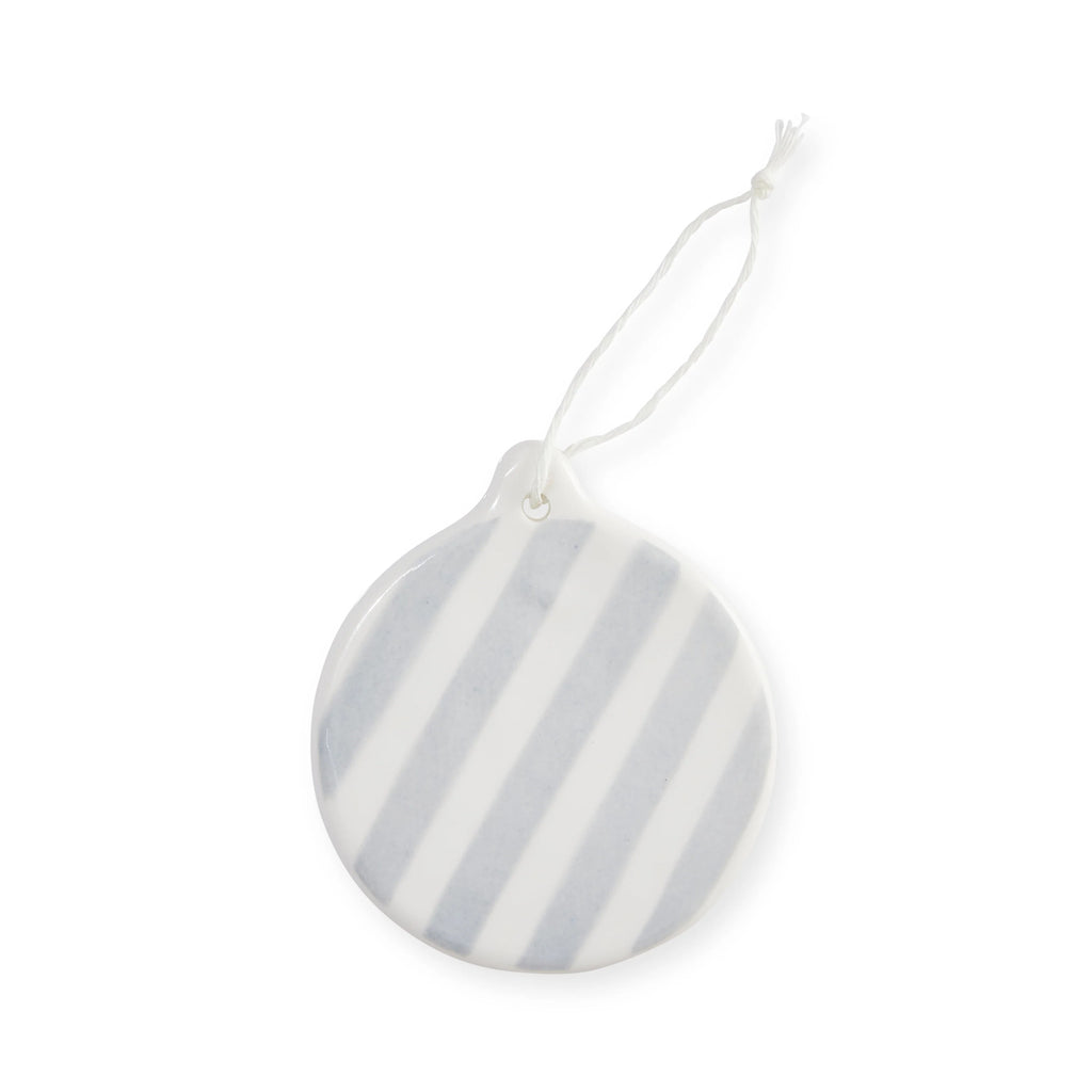 Round ceramic hand painted ornament with light blue and white stripes on a white background