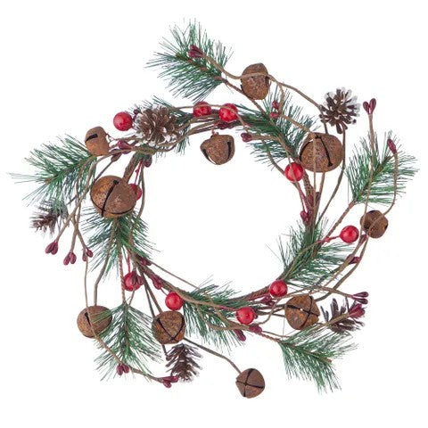 Decorative candle wreath with pine cones, berries, and rusty jingle bells on a white background