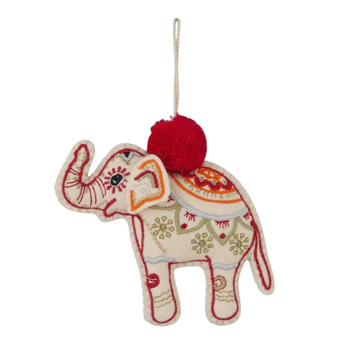 Decorative embroidered elephant ornament with red pom-pom on a white background