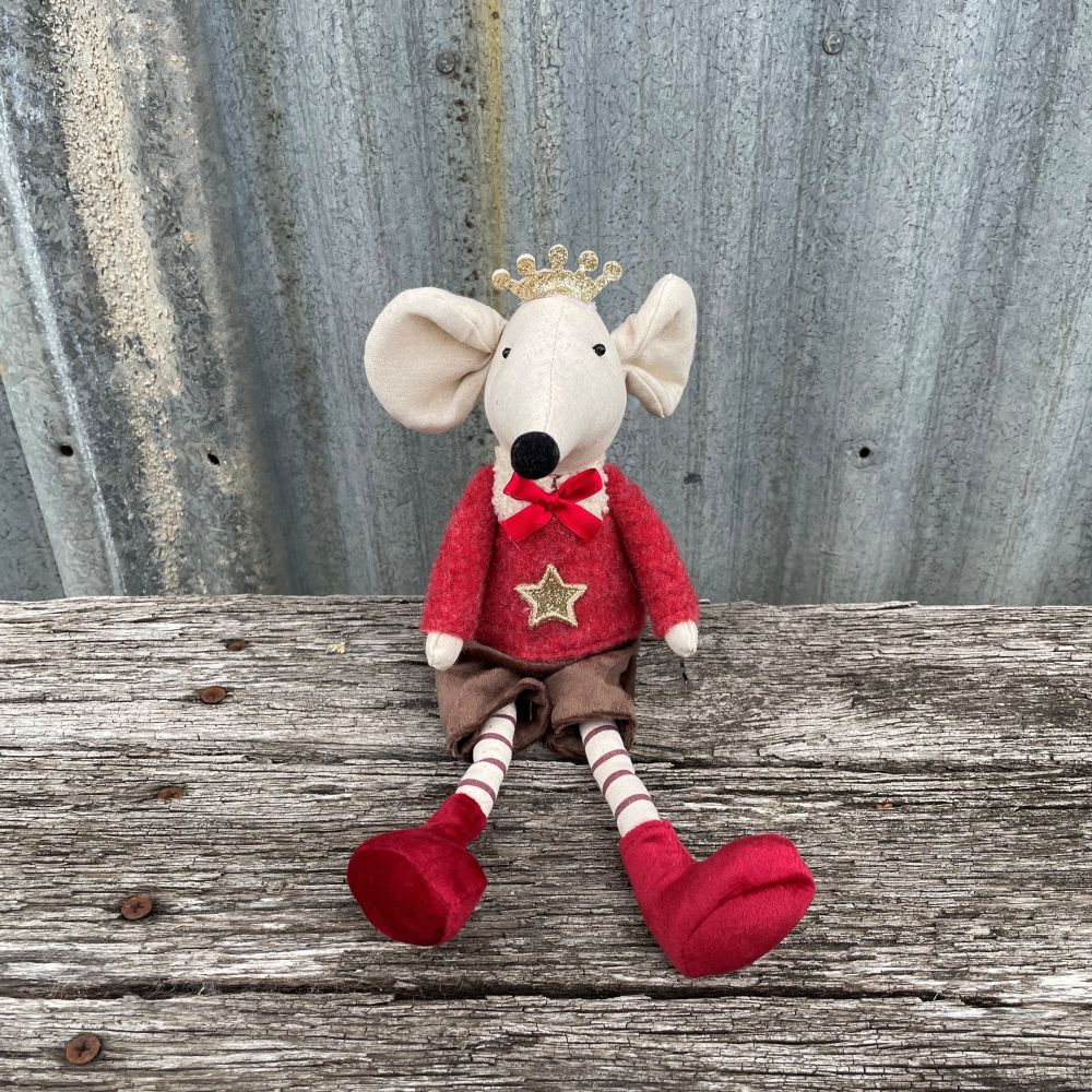 Fabric mouse decoration in a red outfit with a star and a crown on sitting on a wooden surface