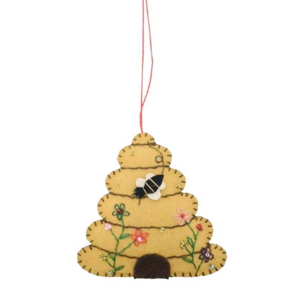 Decorative ornament shaped like a beehive with a bee and flowers on a white background