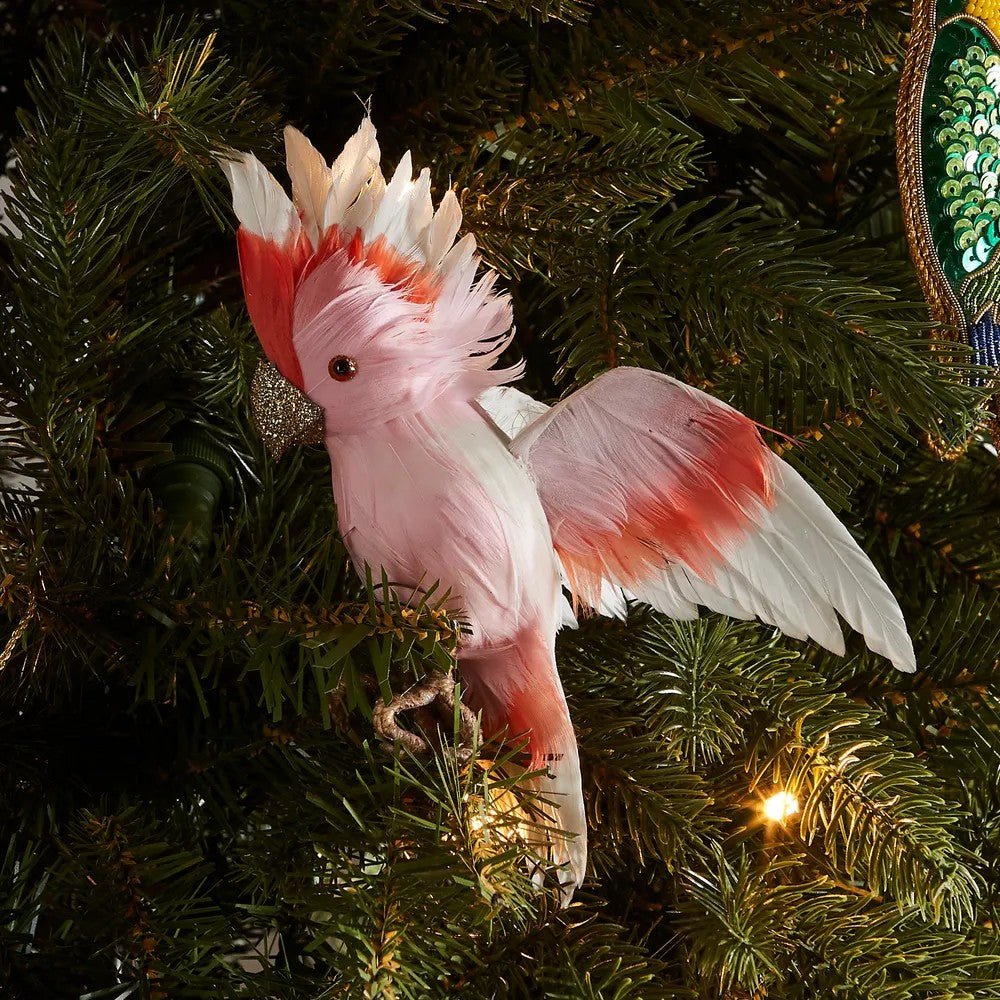 Decorative pink and orange Major Mitchell bird ornament on a Christmas tree.