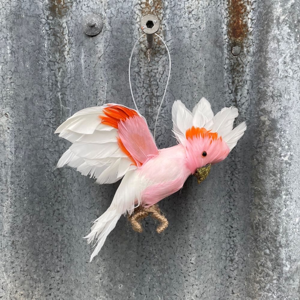 Decorative Major Mitchell Cockatoo flying feathered bird ornament on a textured metal surface
