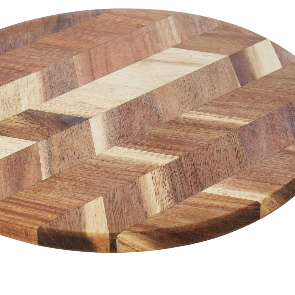 Round wooden cutting board with a herringbone pattern on a white background