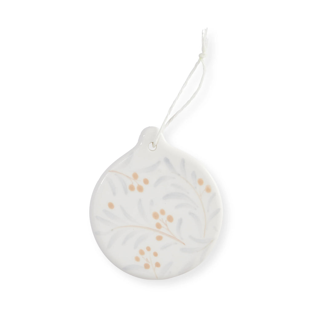 Round Juniper hanging white ornament with subtle design of blue leaves and apricot berries on a white background