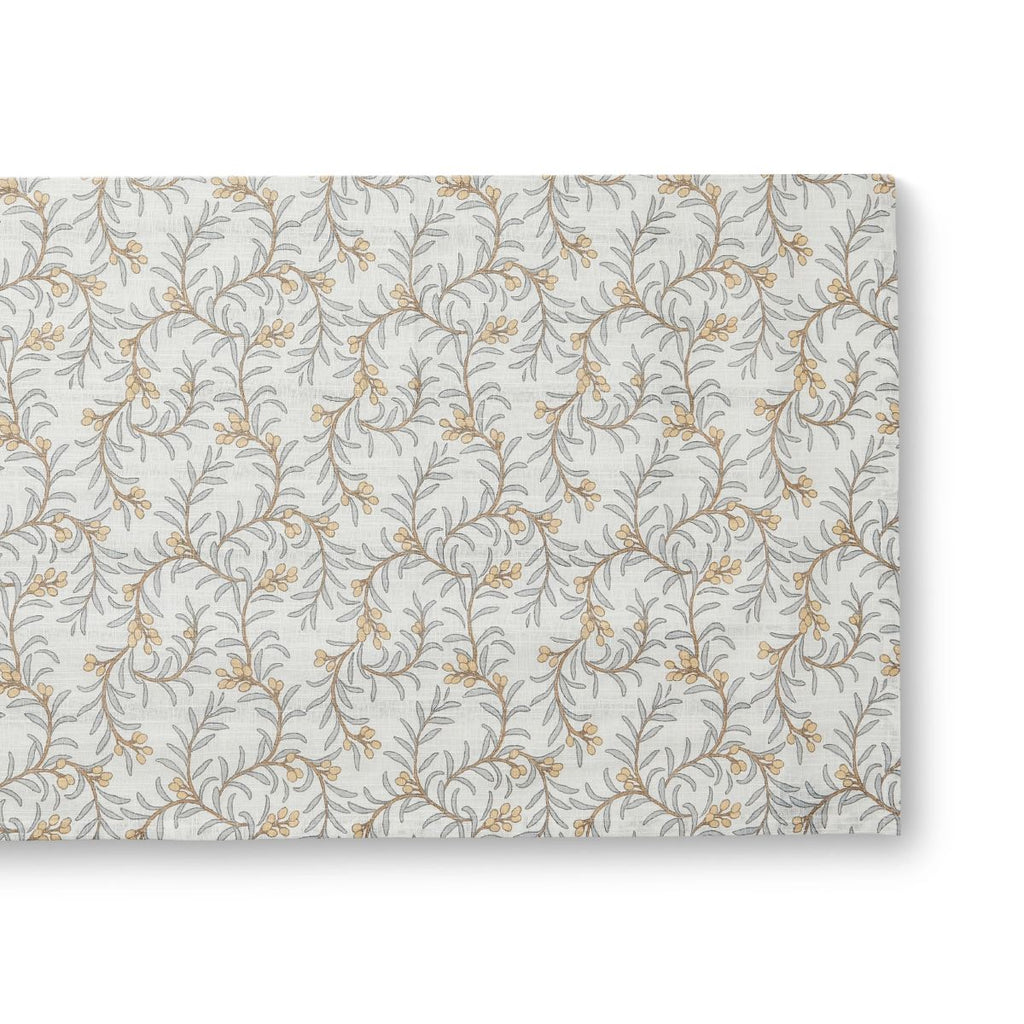 Juniper table runner depicting branches with blue leaves and apricot coloured berries on neutral background