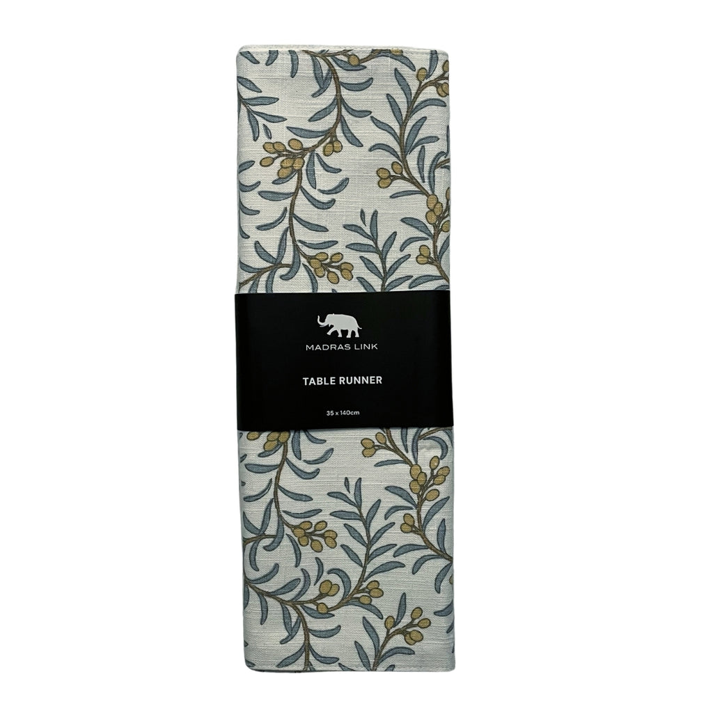 Juniper berry and leaf patterned table runner with a black label on a white background