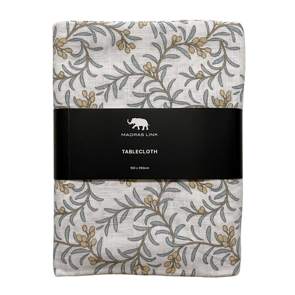 Folded Juniper berry and leaf patterned tablecloth with a Madras Link label on a white background