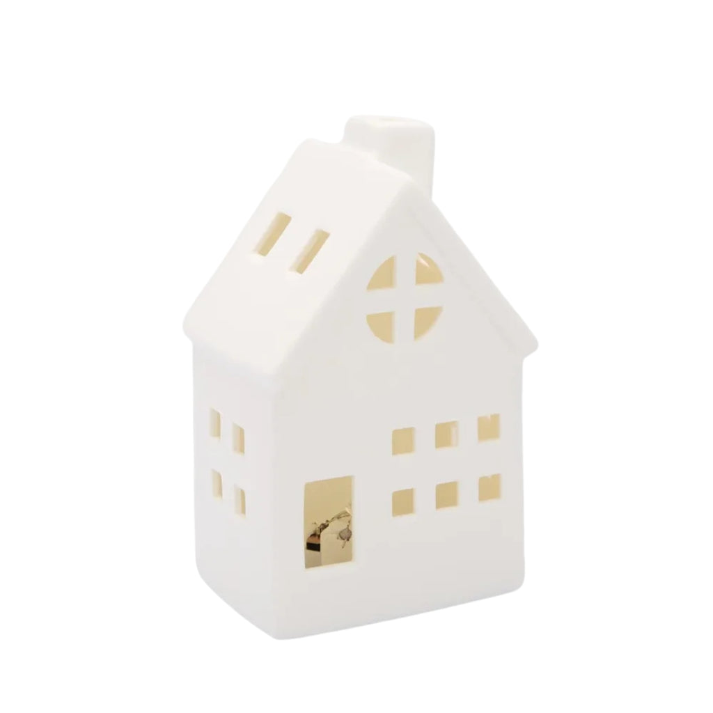 Small White porcelain house with chimney, windows and LED light inside, on a white background