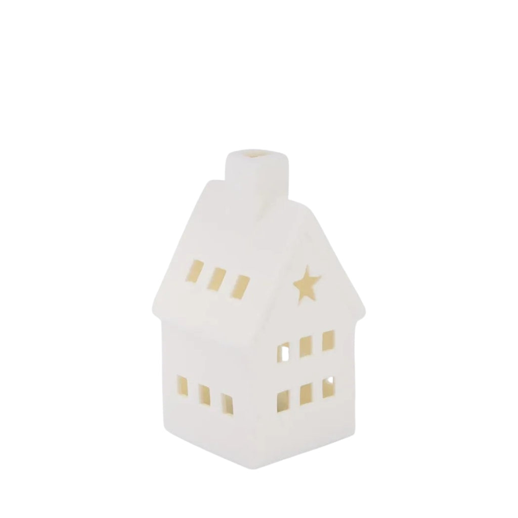 White porcelain house with chimney, windows and star cut out with LED light on a white background