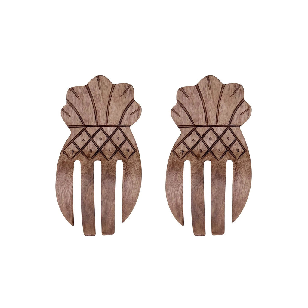 Pair of wooden salad servers with geometric patterns in shape of pineapple on a white background