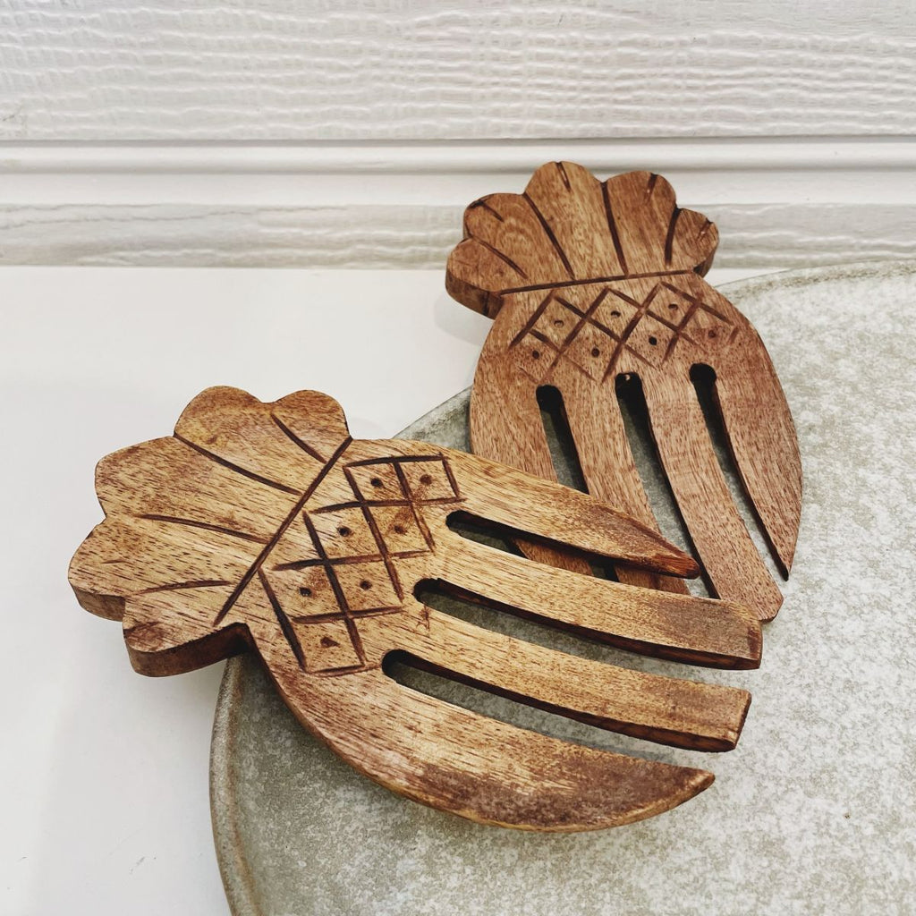 Pair of wooden Marley salad servers on serving platter