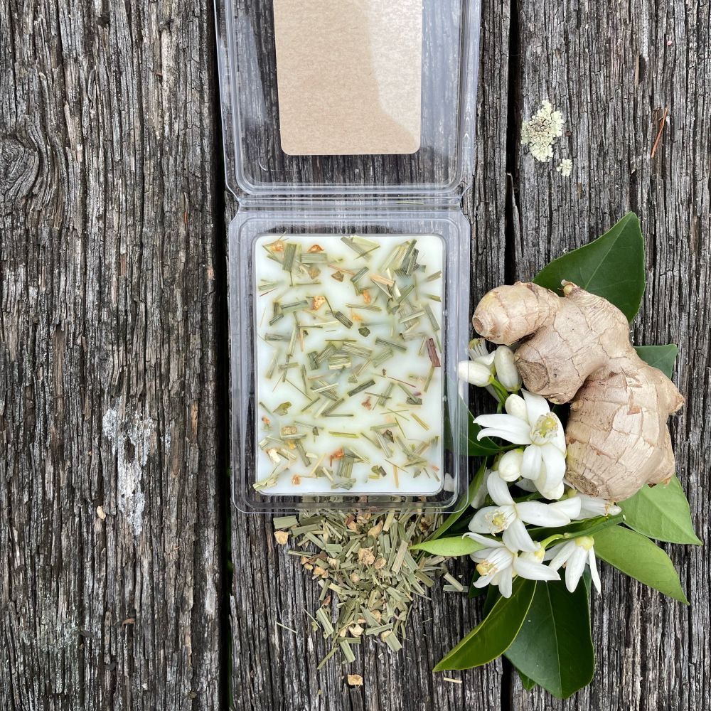 Twig and Feather - Soy Wax melts in open package with Fresh lemongrass and ginger on a wooden surface