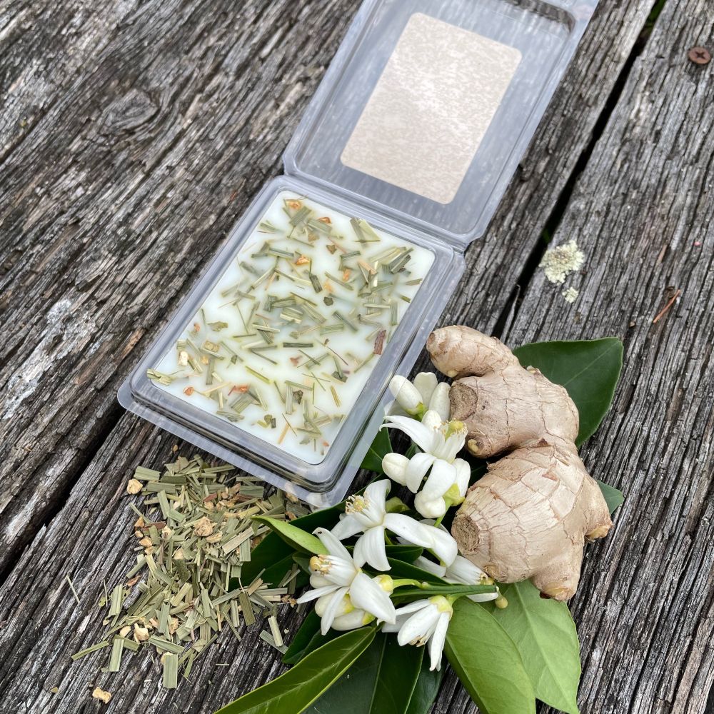 Twig and Feather - Soy Wax melts in open package with Fresh lemongrass and ginger on a wooden surface