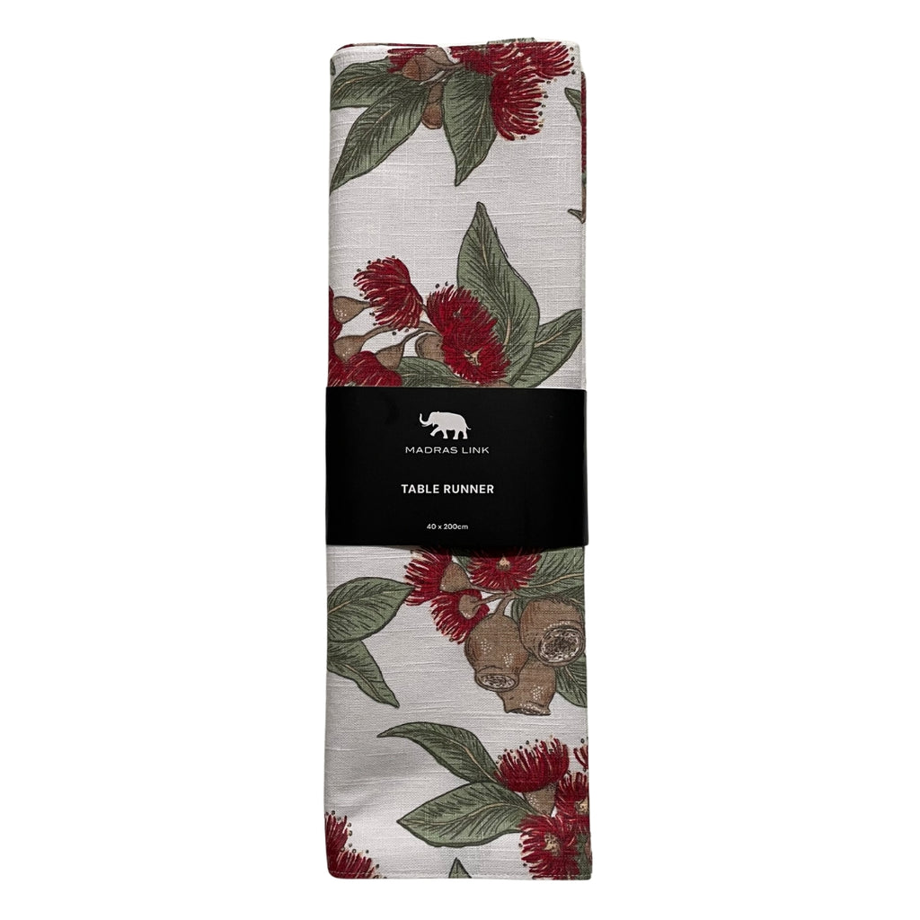 Red Flowering gum table runner folded with a Madras Link label on a white background
