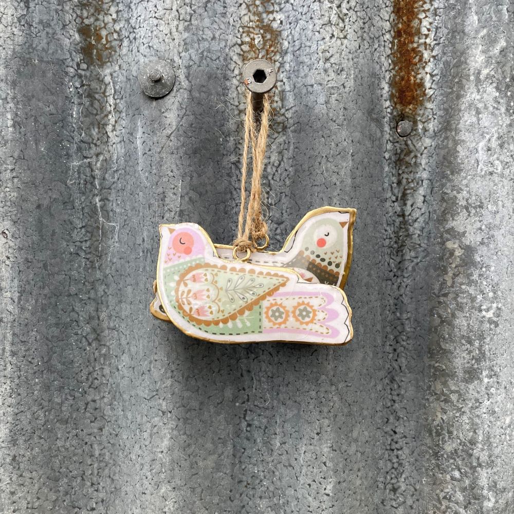 Decorative Metal Nordic bird ornaments hanging on a textured metal surface - set of 2