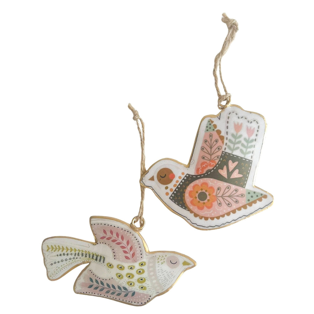 Decorative bird ornaments with floral patterns on a white background