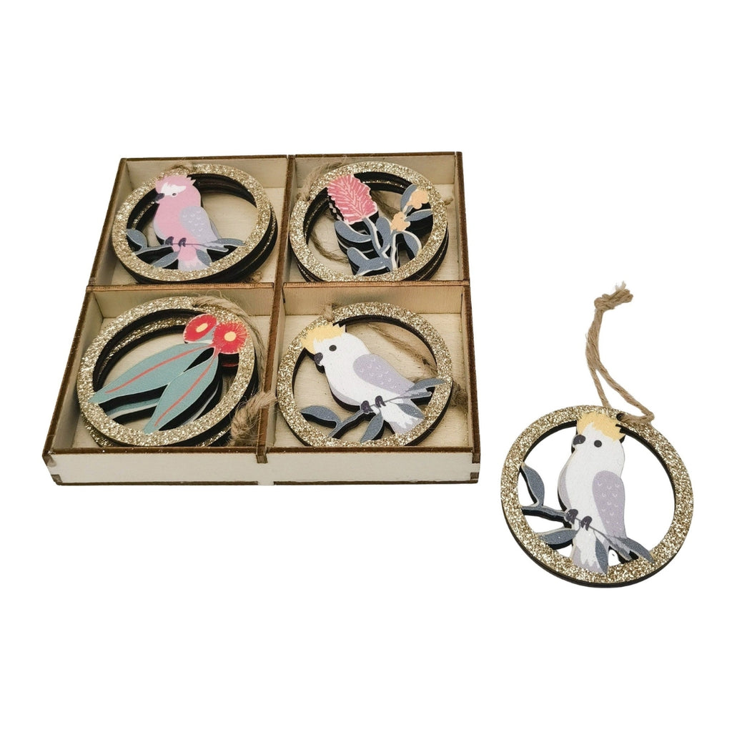 Set of decorative Australian bird and flower ornaments in a box with one ornament displayed separately.