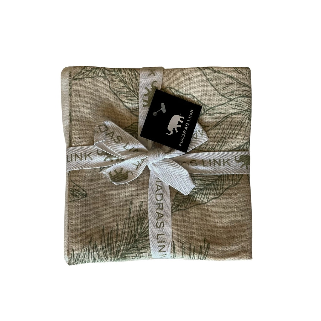 Packaged set of 3 tea towels with pomegranate and pine pattern folded with a ribbon and label on a white background