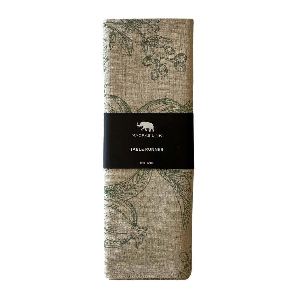 Table runner with pomegranate and pine line drawing design in packaging on a white background