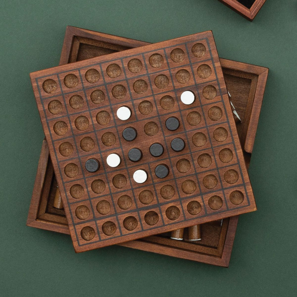 Wooden Reversi game board with pieces on a green background - available from Twig and Feather
