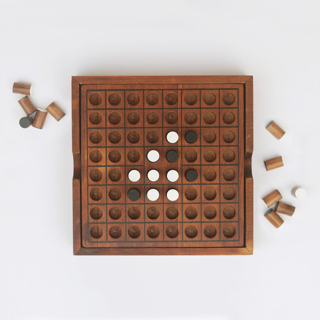 Wooden Reversi game board with pieces on a white background - available from Twig and Feather