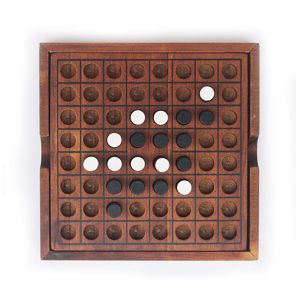 Wooden Reversi game board with circular holes and white and black pegs on a white background - - available from Twig and Feather