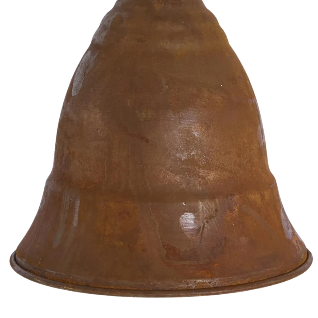 Rust-colored curved bell hanging on a white background - closer detail
