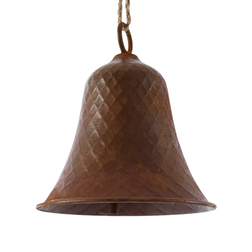 Rusty bell with textured dimple surface on a white background