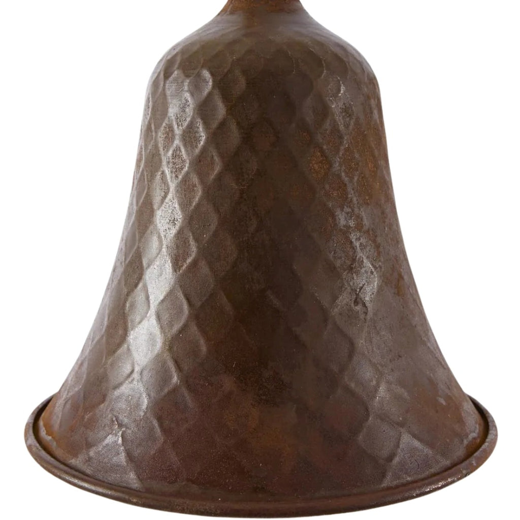 Rusty bell with textured dimple surface on a white background - more detailed look