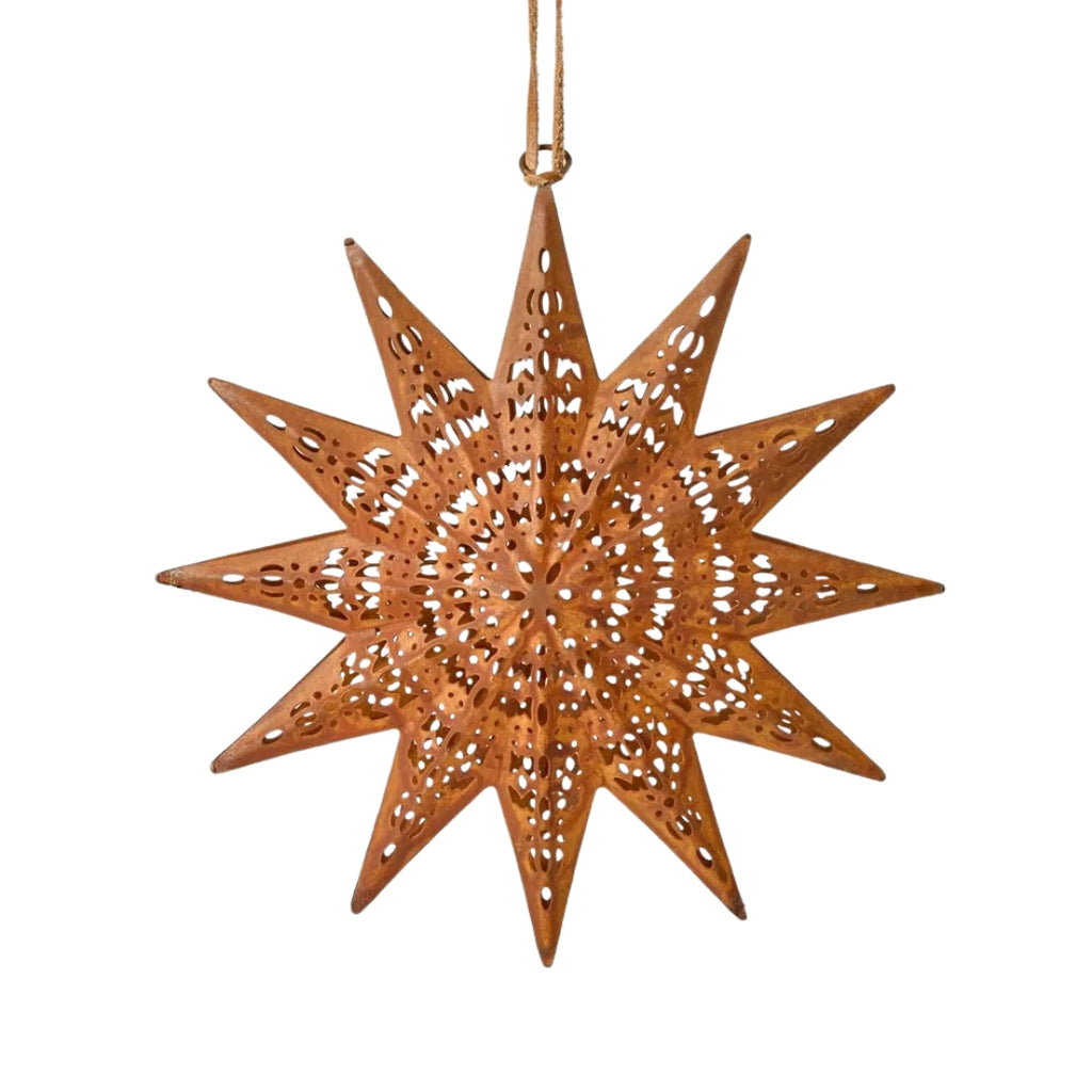 Decorative rusty etched star-shaped ornament with cut-out patterns on a white background