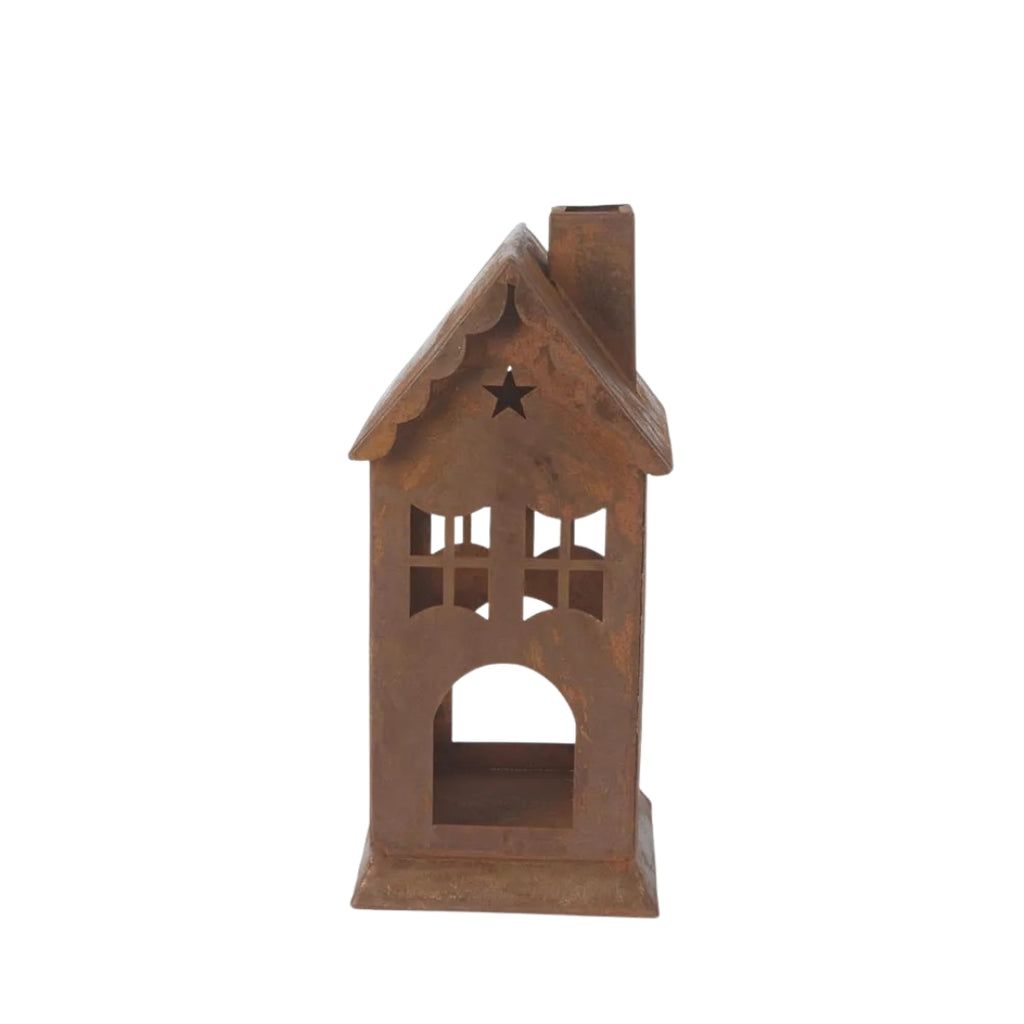 Rusty metal lantern or candle holder in house design on a white 