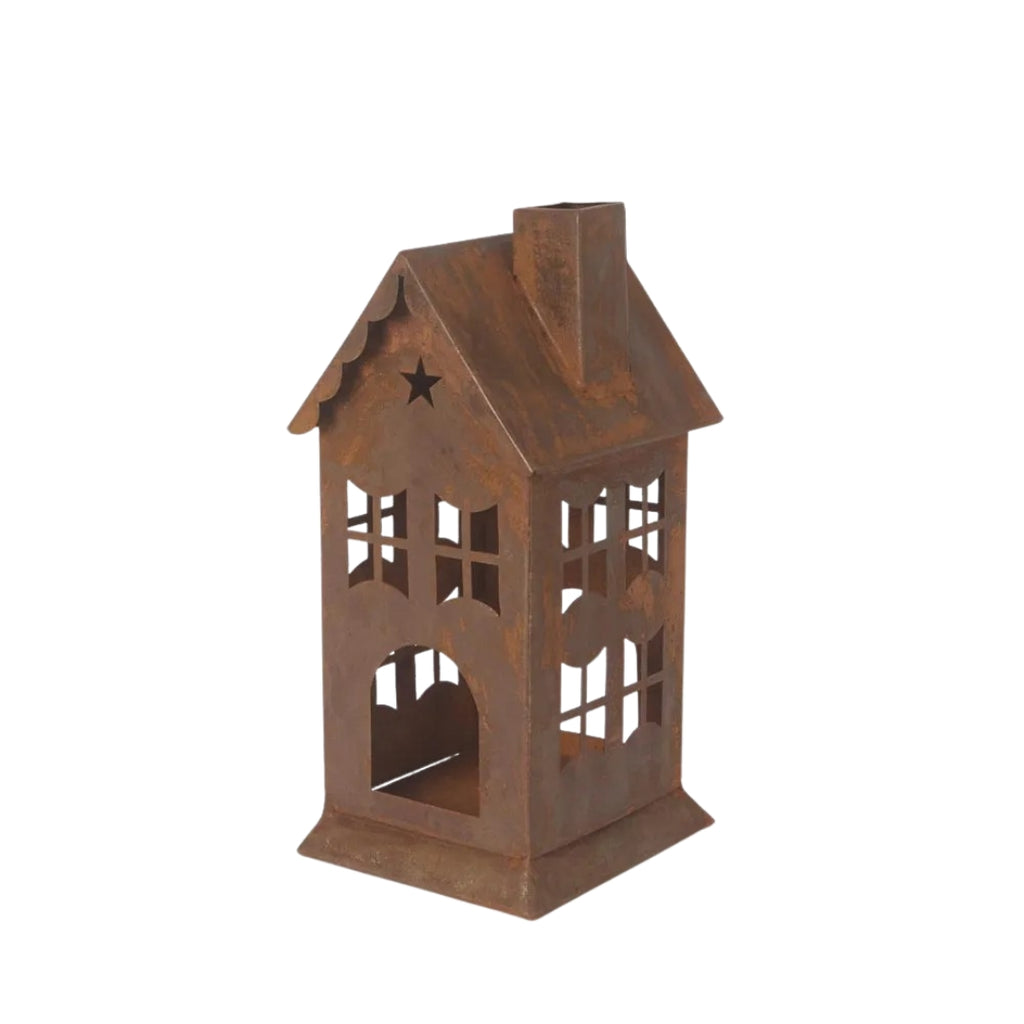 Rusty metal lantern or candle holder in house design on a white 