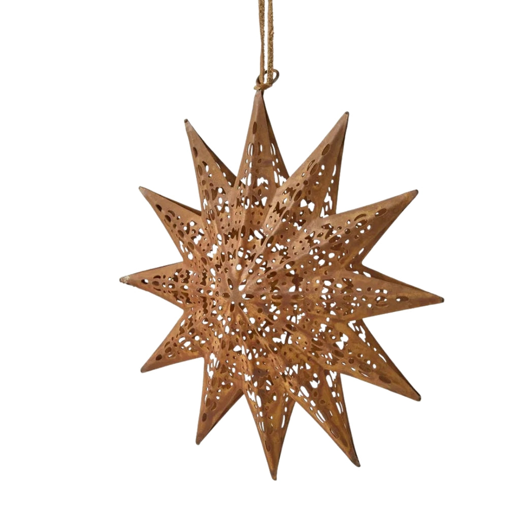 Decorative rusty etched star-shaped ornament with cut-out patterns on a white background