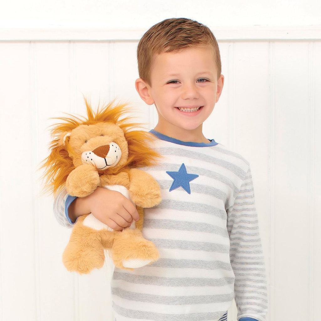 Child holding a Snuggable Hottie lion plush toy against a white background