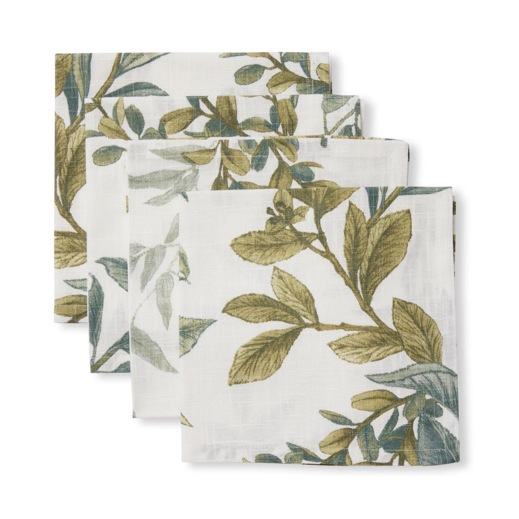 Set of four green leaf-patterned napkins on a white background