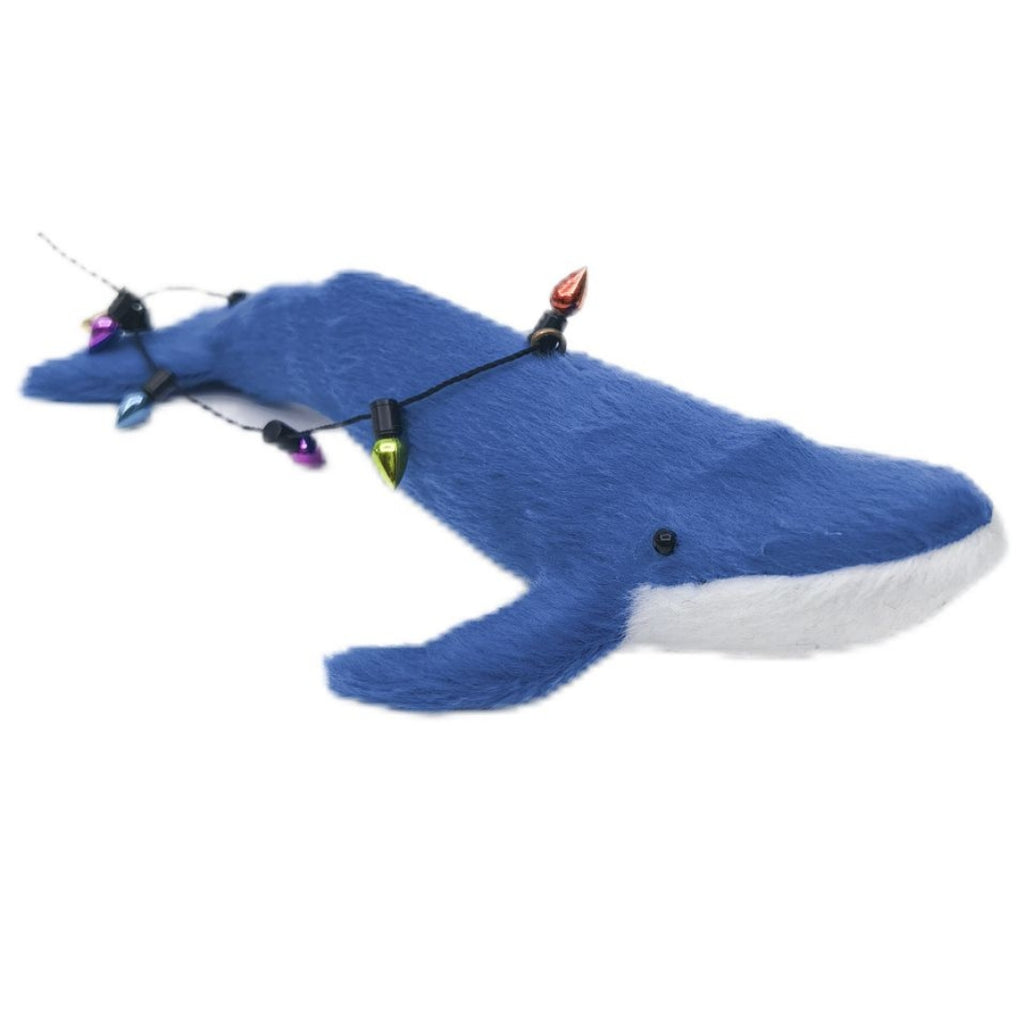 Blue whale decoration with string of lights on a white background