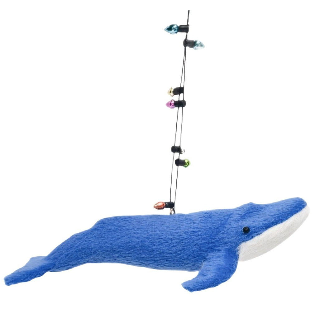 Blue whale decoration with string of lights on a white background