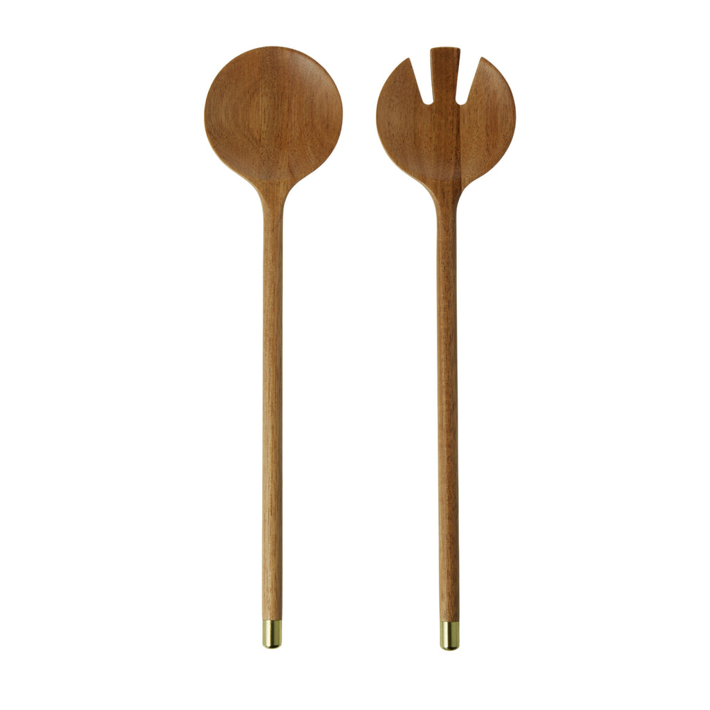 Acacia wood salad servers set with brass tips on a white background