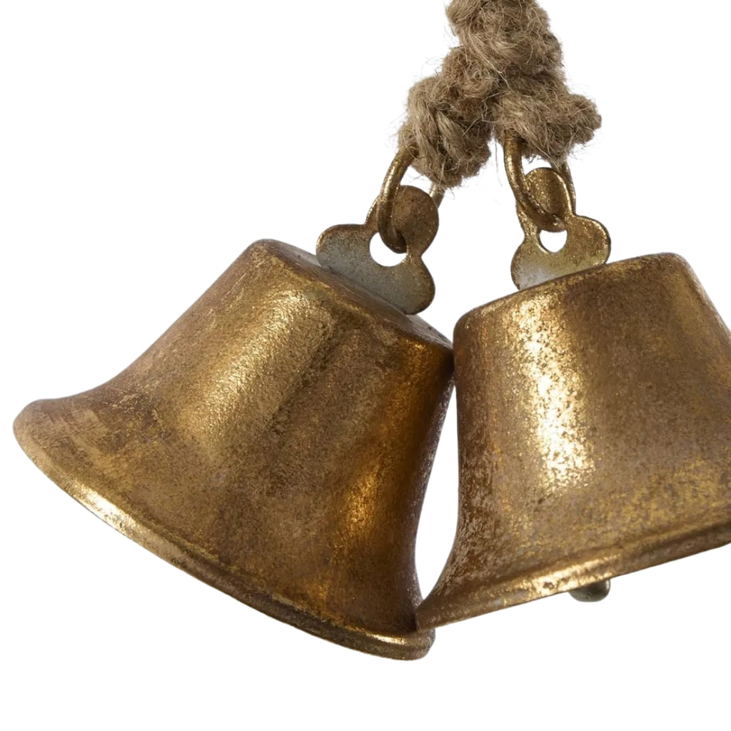 Pair of antique style gold bells on a white background
