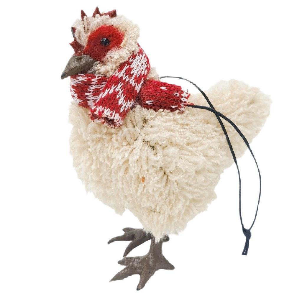 Hanging Christmas chicken decoration with a red and white knitted scarf on a white background