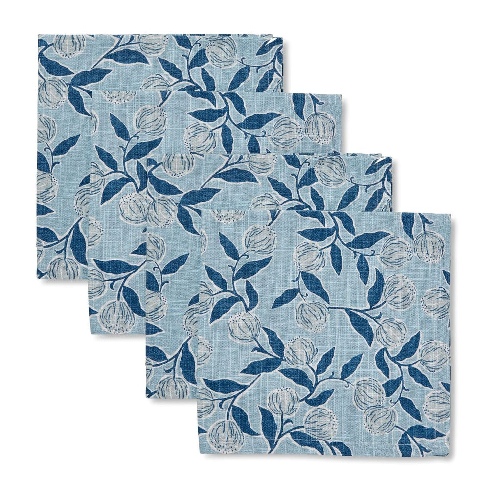 Set of four blue floral patterned placemats on a white background