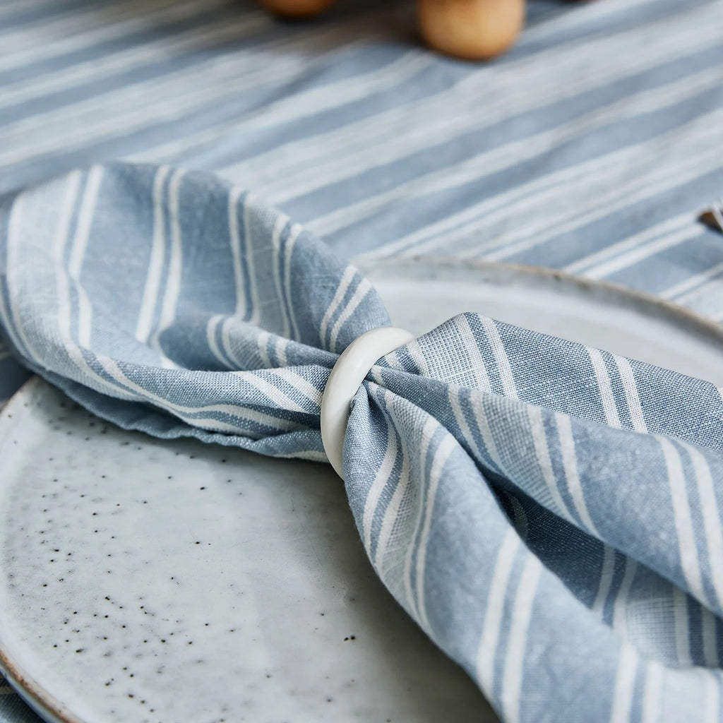 Blue and white striped cloth on a ceramic plate