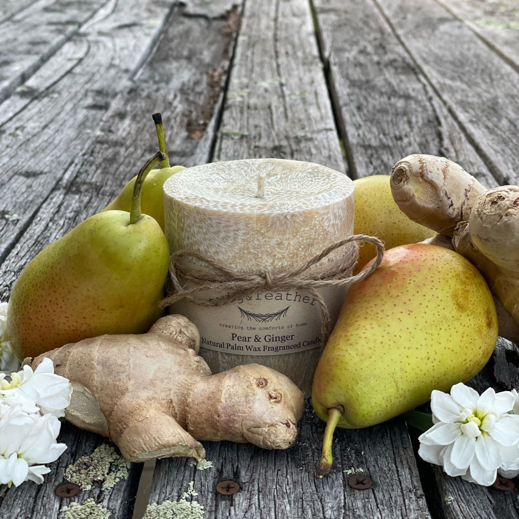 Twig and Feather Pear & Ginger Palm wax pillar 38 hour Candle with ginger and pears on a wooden surface