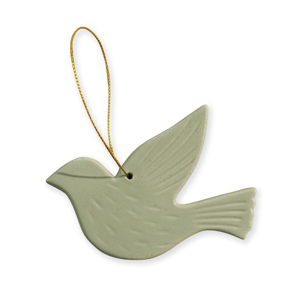 Green ceramic dove ornament with a gold string on a white background