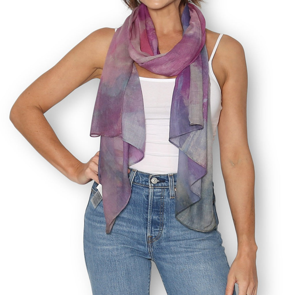 Woman wearing The Artist Label Feminism scarf in purples, violets, lilacs and hinds of gold. 
